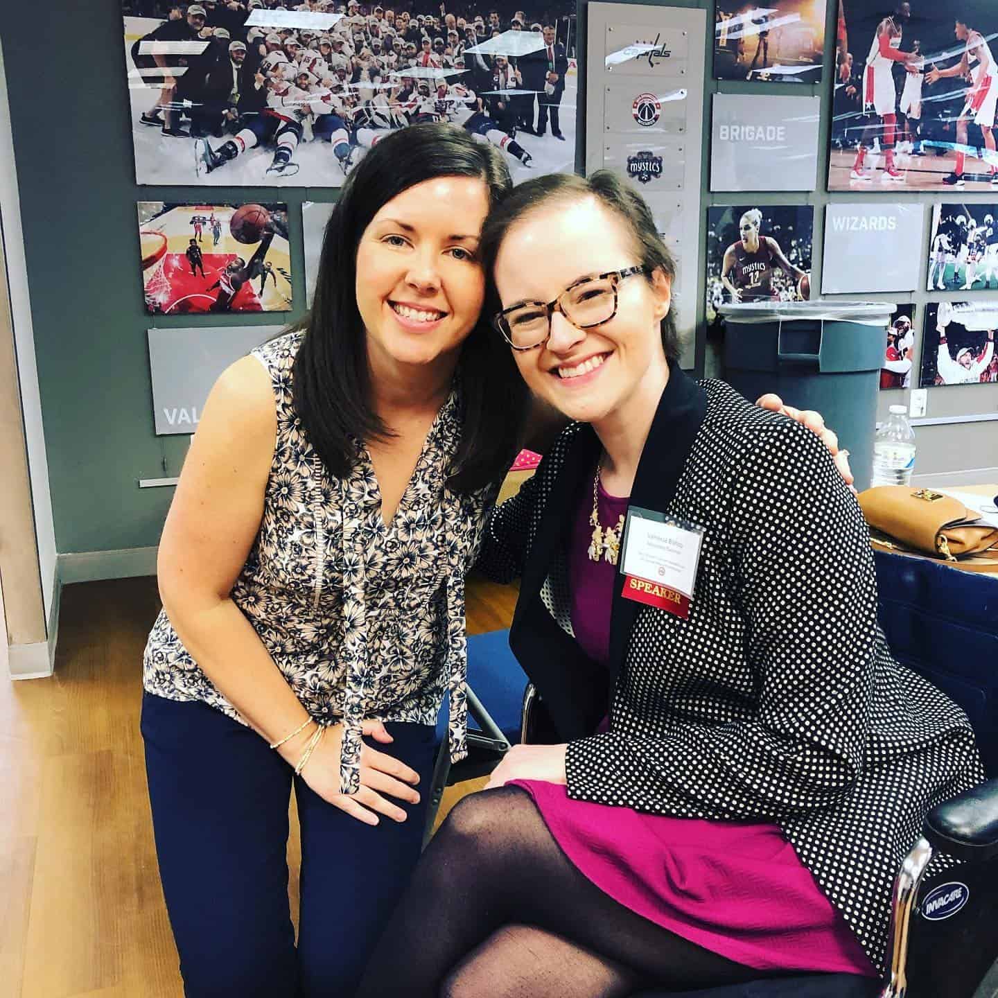 Two women smiling together in a casual setting.