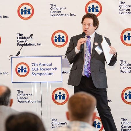 Man speaks at podium during the 7th Annual CCDI Research Symposium.