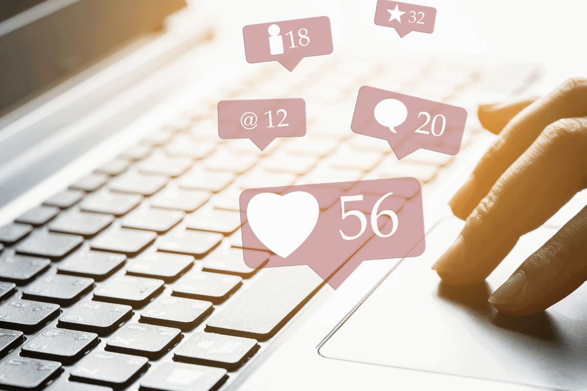 Social media engagement icons floating above a keyboard.