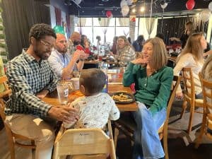 Family enjoying a meal together at a busy restaurant.